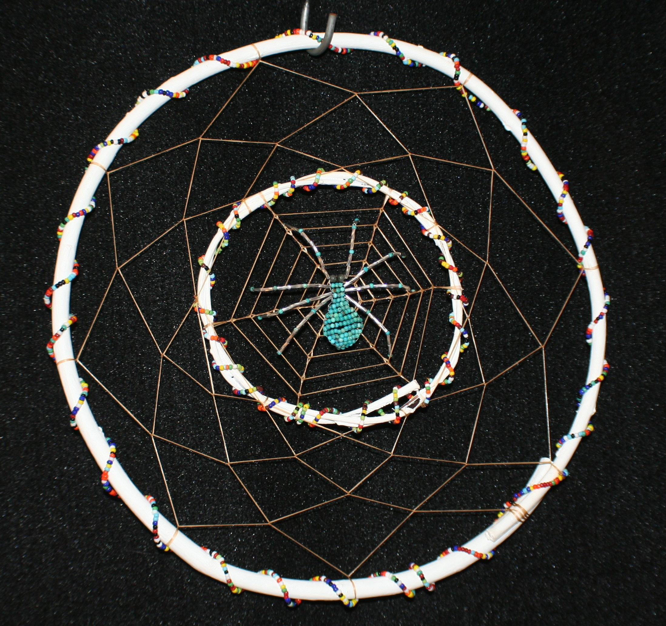 dream weaver dreamcatcher by john pete with two hoops and two styles of weaves and turquoise beaded spider 